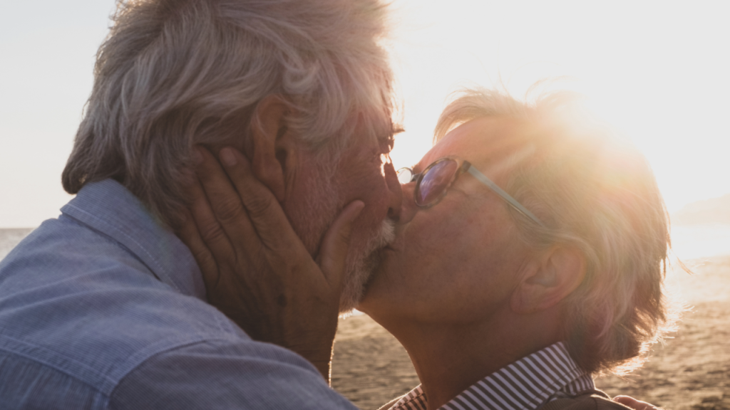 Elderly couple happy and in love.  Sharing a kiss and celebrating many years together.